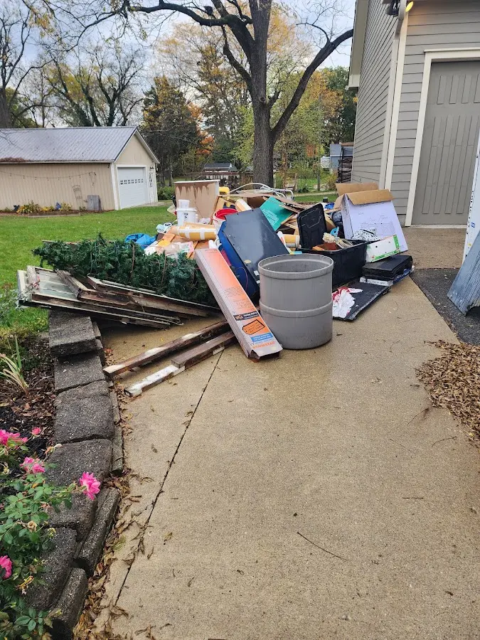 Dumpster being loaded with debris for 10 Yard Dumpster Rental in Greenwood